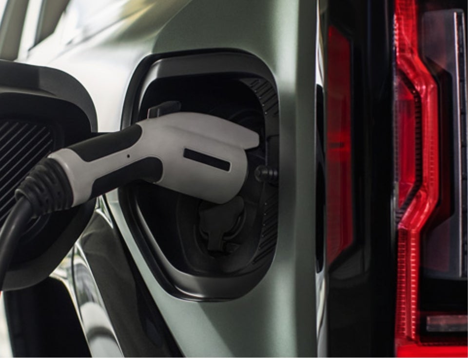 Close up of charging port with charger plugged in on a GMC Hummer EV SUV - Alderman's Chevrolet GMC in Rutland VT