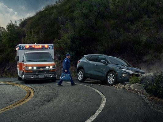 a paramedic walking over to a crashed vehicle