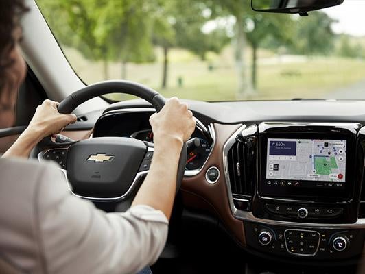 A person driving a car using the navigation