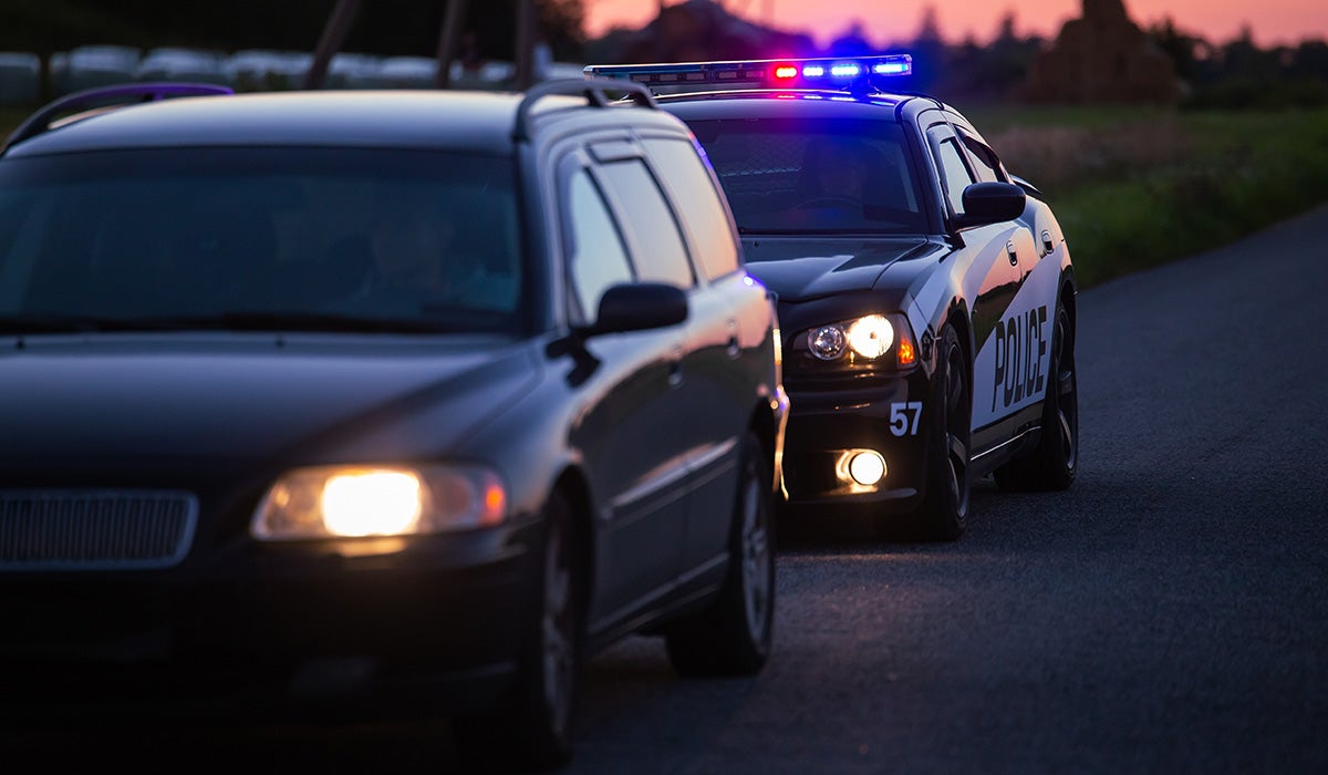 Police vehicles driving with sirens on